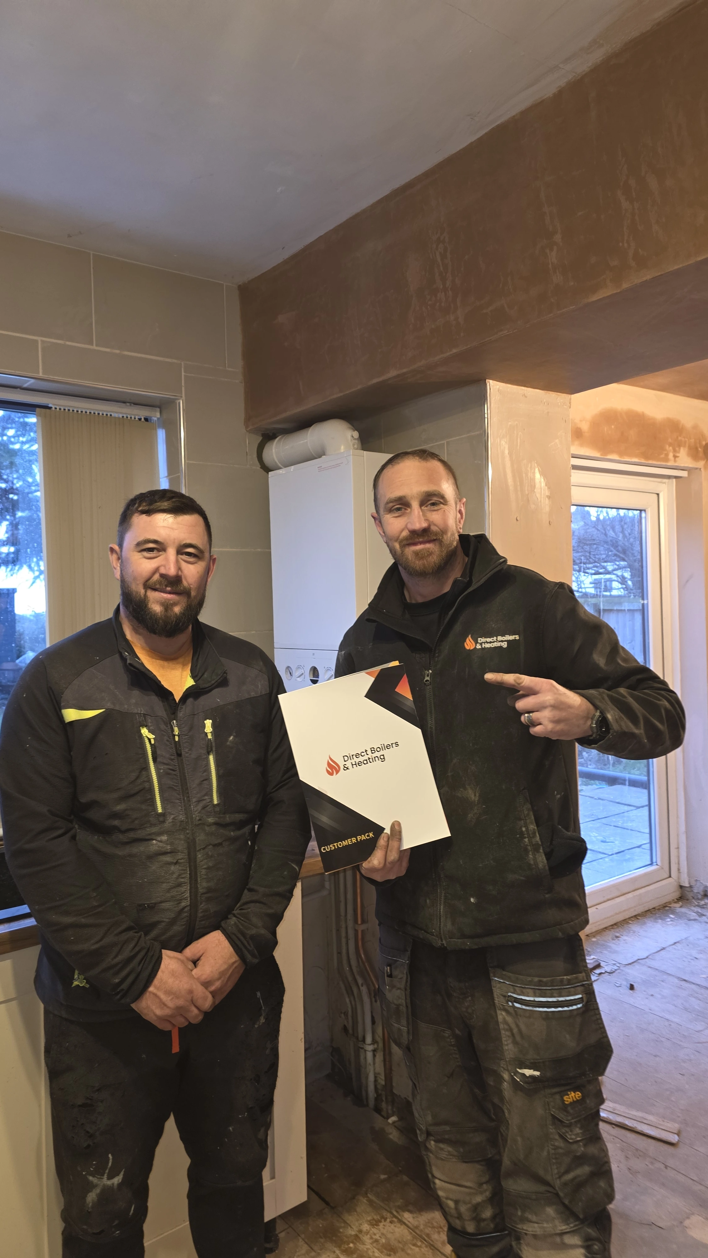 Direct Boilers team with customer indoors