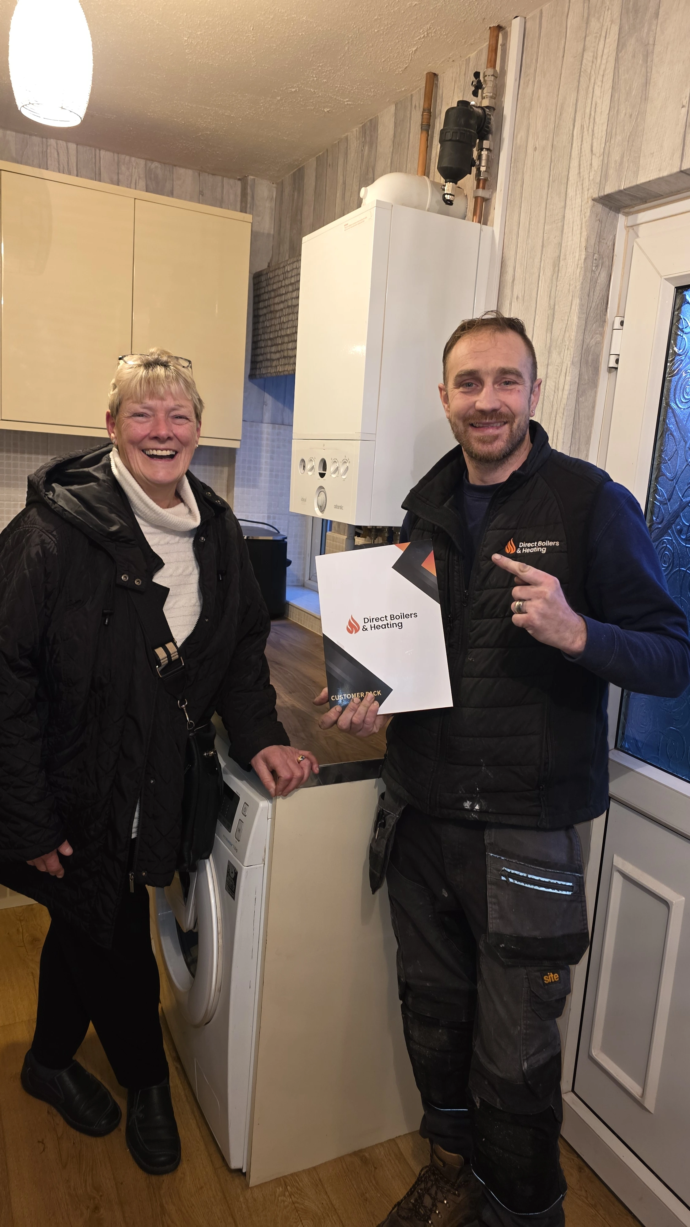 Engineer with customer after boiler installation